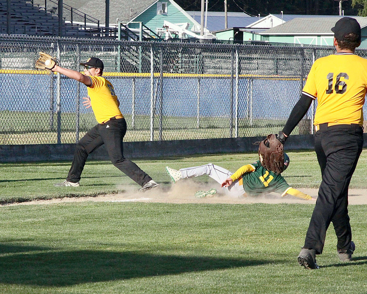 No. 11 Sean Lyman of the Laurel Lanes team slides safely into third base on a wild pitch from #16 Kaleb Mullen the pitcher. The third baseman for Elks is Joseph Ritchie taking the throw.