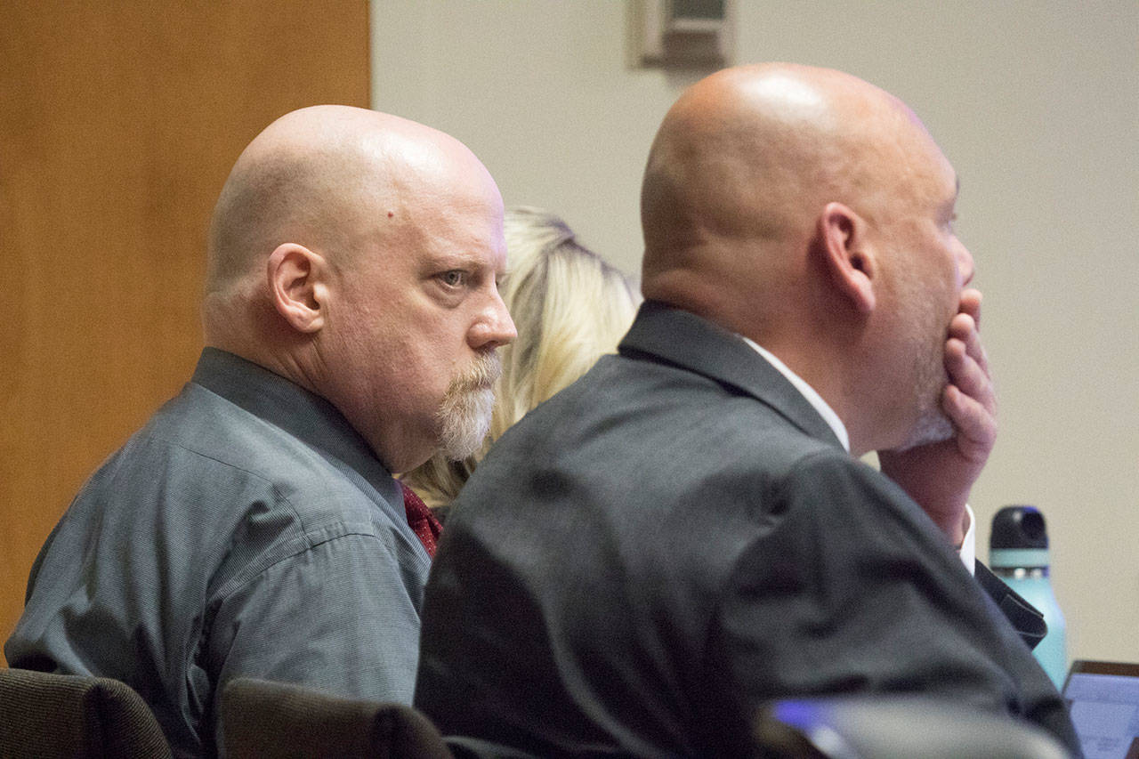 William Talbott II, left, stares at his attorney Jon Scott after Scott presented his opening statement in Talbott’s trial for double-murder Friday at the Snohomish County Courthouse in Everett. (Andy Bronson/The Herald via AP, Pool)