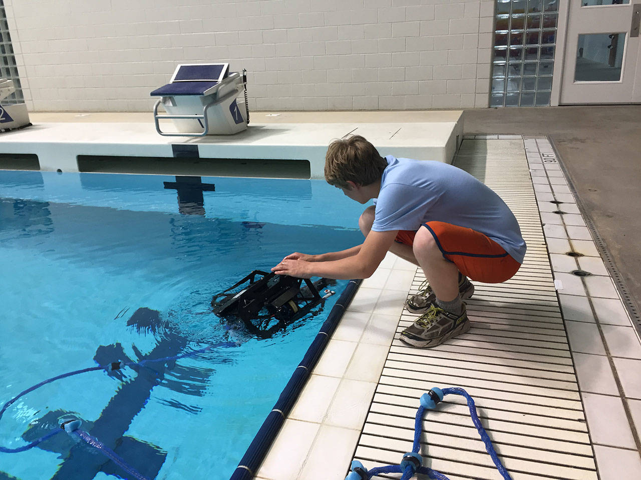 The Sea Dragons tether manager Everest Ashford retrieves the S.S. Dragon from the pool during practice. (Ella Ashford)