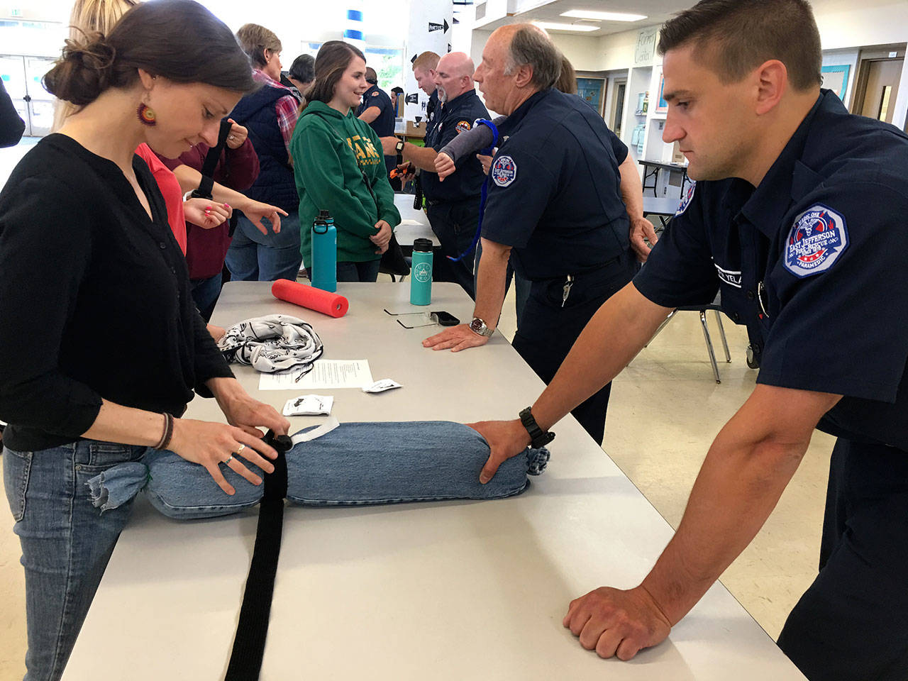 East Jefferson Fire-Rescue team member Pete Yelaca teaches how to apply a tourniquet during the Chimacum School District’s “Stop the Bleed” training Monday. (East Jefferson Fire Rescue)