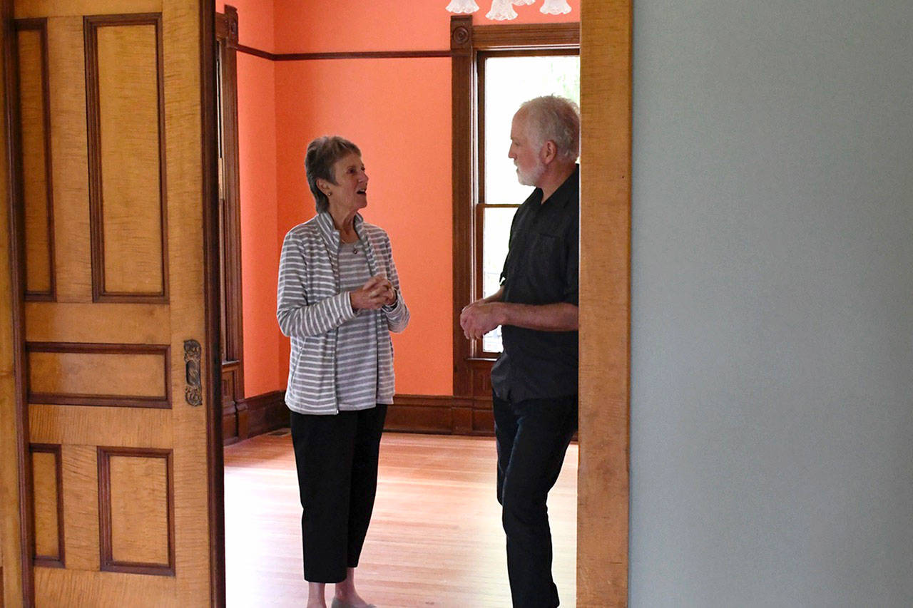Volunteers Christine Satterlee and Brian Cullen discuss the next steps of the interior restoration of the 1892 Worthington Mansion, a project that has been funded by private donors, charitable organizations, and state and federal funds. (Jeannie McMacken/Peninsula Daily News)