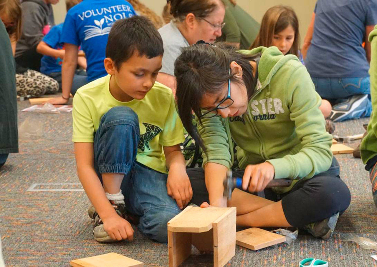 The North Olympic Library System offers two upcoming Build a Birdhouse events events: today in Port Angeles and July 16 in Sequim. Here, participants work on a birdhouse at similar event in 2017. (North Olympic Library System)