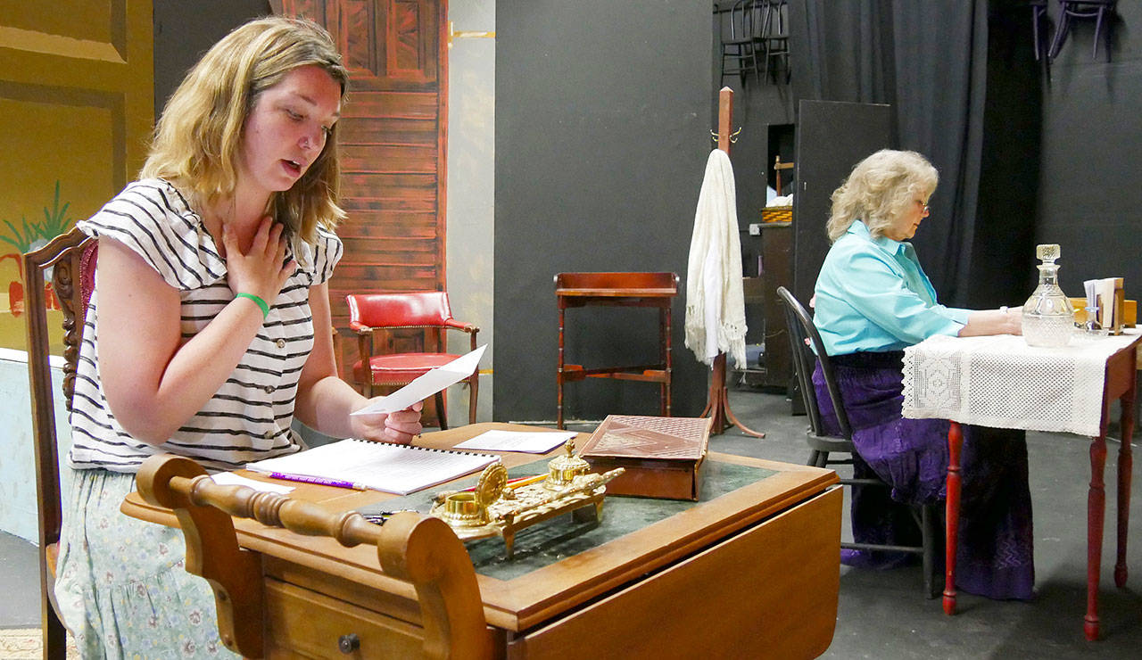 Kait Saffold, left, and Sharon DelaBarre read through the letters they transcribed by hand from the script on a set under construction. (Olympic Theatre Arts)