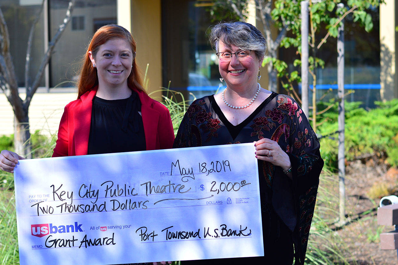 US Bank branch manager Andrea Robertson, left, presents Key City Public Theatre Executive Artistic Director Denise Winter with a donation in Port Townsend. (Diane Urbani de la Paz)