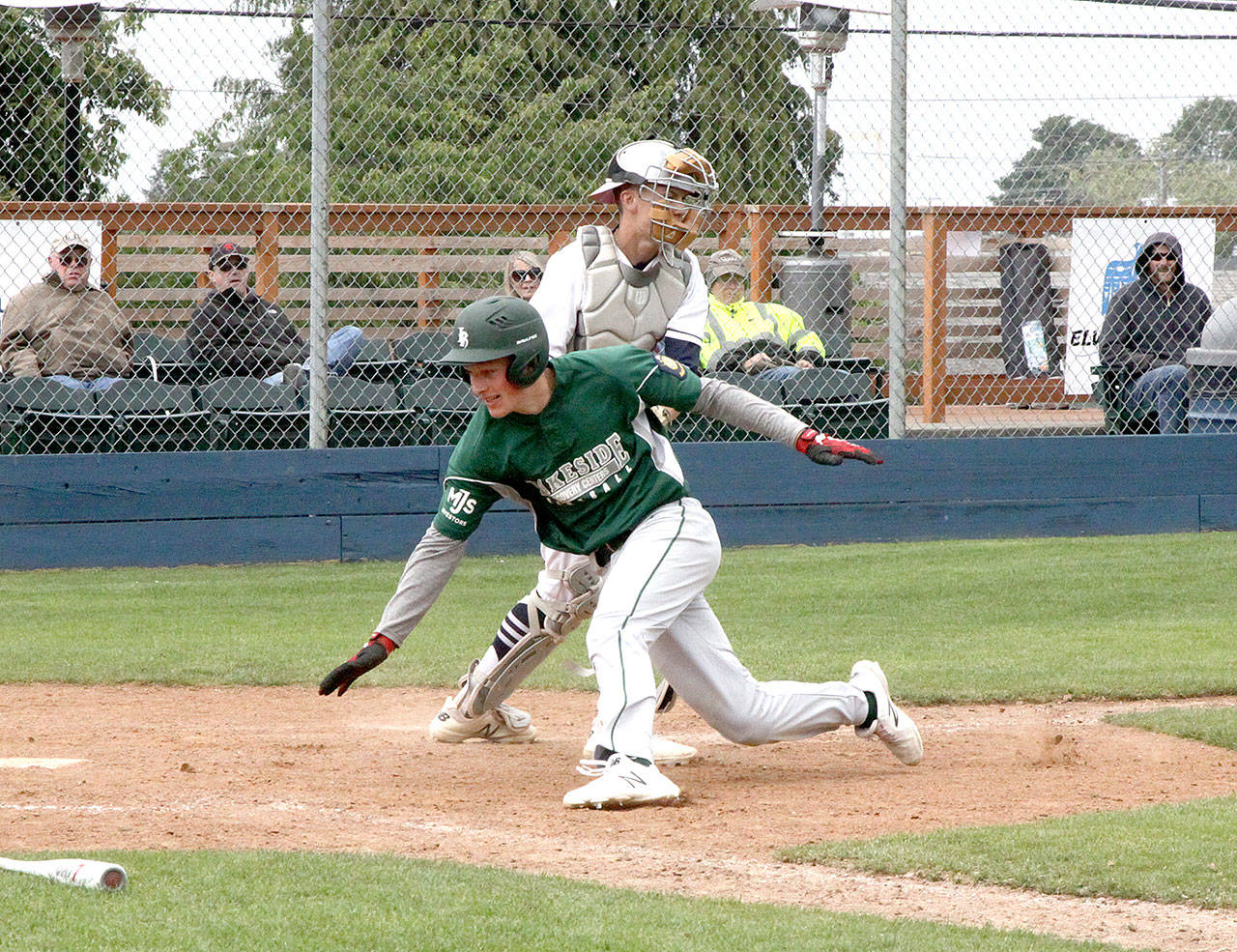 Lakeside’s Nate Moore tries to score around Wilder catcher Joel Wood waits with the ball in his mitt Sunday at Civic Field. Wood held onto the ball and Moore was called out. Wilder split with first-place Lakeside, losing the first game of a doubleheader 3-0, but winning the nightcap 5-4. (Dave Logan/for Peninsula Daily News)