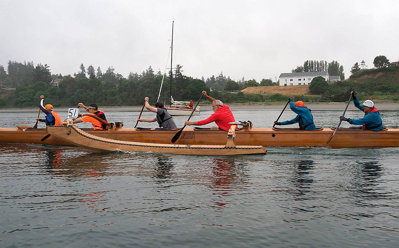 Michael Lampi/Sound Rowers The KOLOA, a six-person wooden outrigger canoe with crew from Westport, Aberdeen, Bothell and Iowa, competed in the 25th annual Rat Island Regatta last Saturday off Port Townsend.