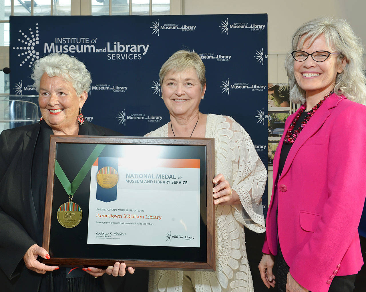 Accepting the award for the Jamestown S’Klallam Tribal Library are, from left, Liz Mueller, tribal council vice chair; and Celeste Dybeck, tribal elder. To the right is Kathryn “Kit” Matthew, director of the Institute of Museum and Library Services.