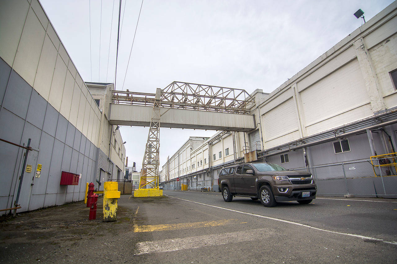 A vehicle passes through the McKinley Paper Company mill in Port Angeles on Monday. The company will seek job applicants July 11. (Jesse Major/Peninsula Daily News)