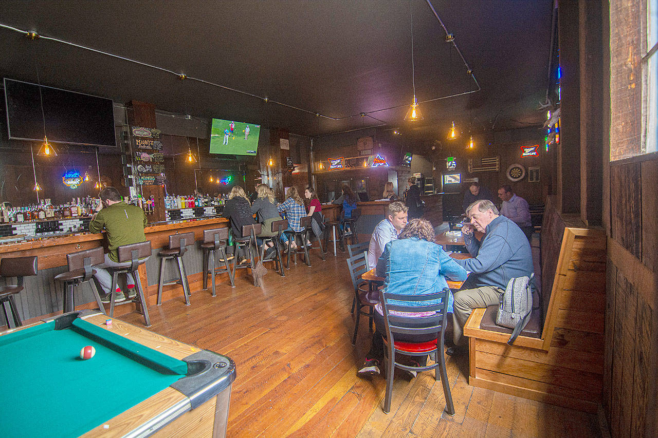 People talk and enjoy drinks during the opening of the new Port Angeles bar Thursday. (Jesse Major/Peninsula Daily News)