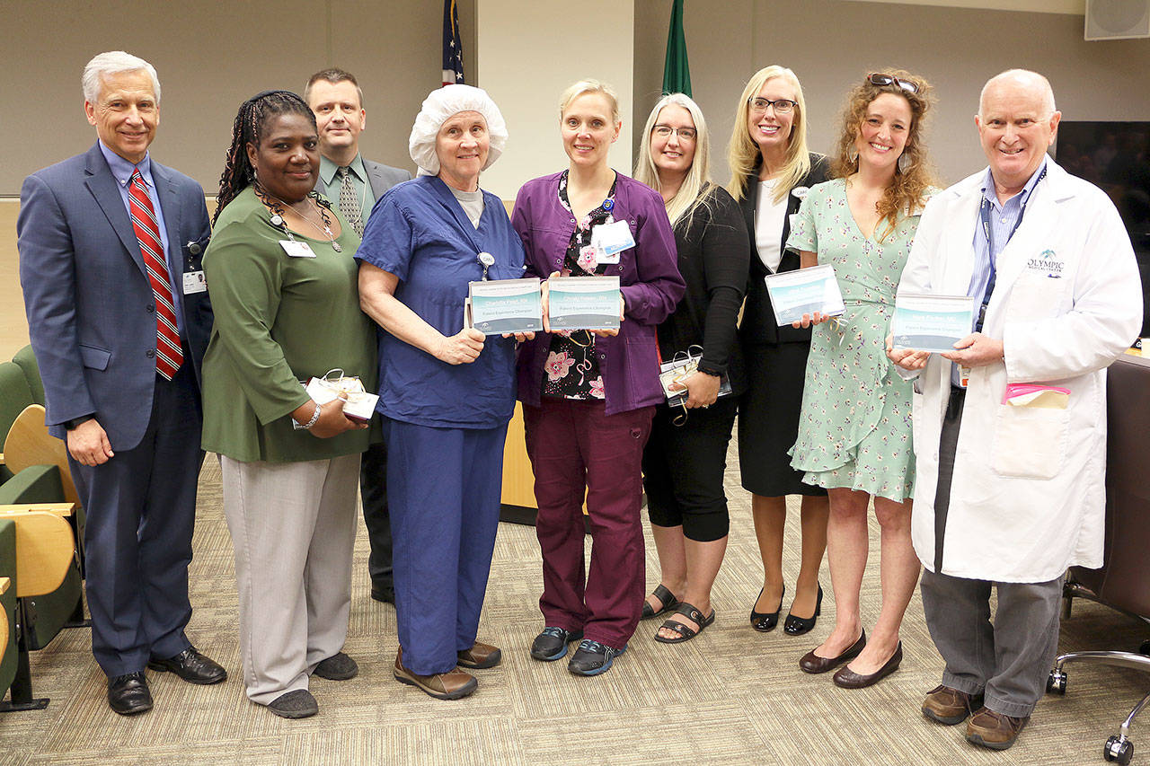 From left to right, CEO Eric Lewis, Lisa Glynn, Board President John Nutter, OR Clinical Educator Ellen Adams accepting the award on behalf of Charlotta Pearl, Director of ICU/Telemetry Katrin Junghanns accepting the award on behalf of Christy Ressor, Holly Heustis, Chief Human Resources Officer Jennifer Burkhardt, Mikel Townsley and Mark Fischer, MD.