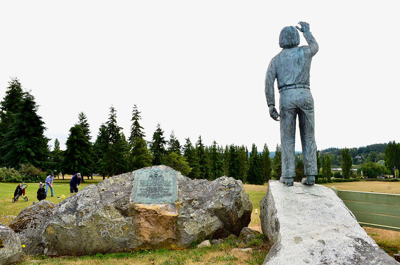 A commemorative statue by Dick Brown depicts Chief Chetzemoka signaling “danger is passed” at Sentinel Rock, sits behind the driving range of the Port Townsend Golf Course. (James Cook/for Peninsula Daily News)