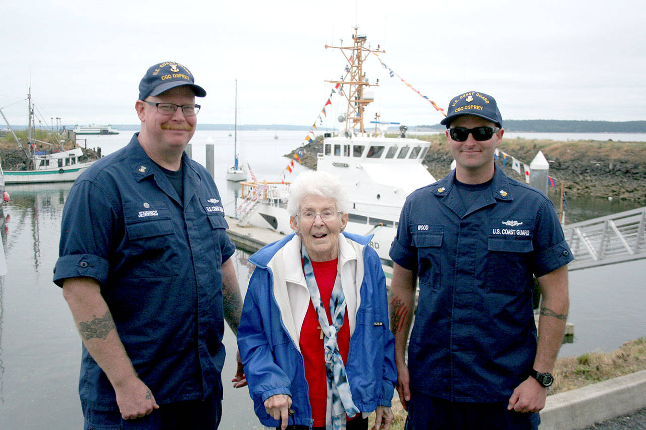Mike Jennings, left, the master chief officer in charge of the U.S. Coast Guard cutter Osprey based in Port Townsend, stands with World War II and Coast Guard SPARS veteran Marjorie Ehnebuske, a yeoman first class, and Kyle Wood, the executive petty officer for the Osprey. (Brian McLean/Peninsula Daily News)