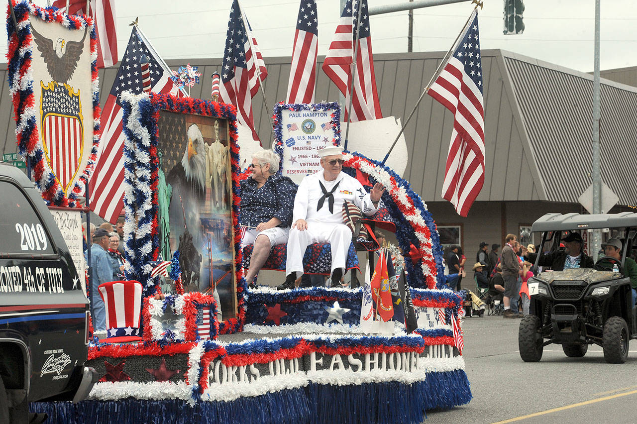 Vietnam veteran Paul Hampton of Forks was chosen as the veteran to ride on the Forks Old Fashioned 4th of July float in Thursday’s parade. His wife, Elsie, accompanied him. (Lonnie Archibald/for Peninsula Daily News)