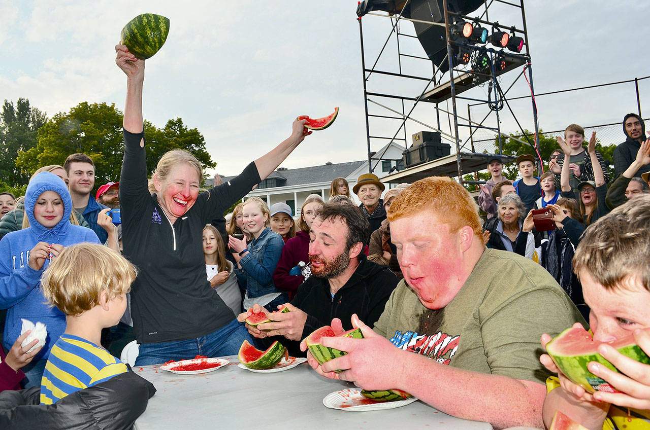 Sharon Hoyer devours half a watermelon in record time during the Old School 4th of July celebration in Port Townsend. (James Cook/for Peninsula Daily News)