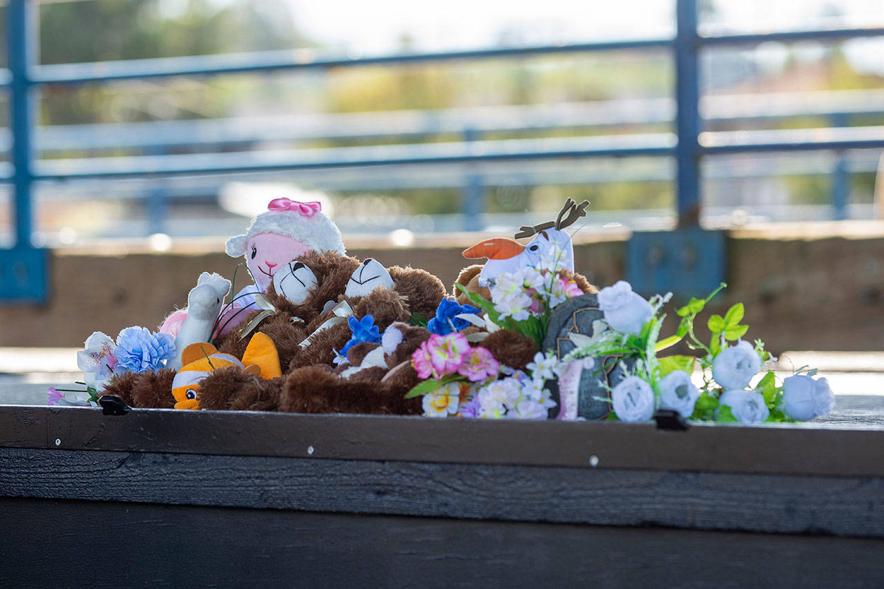 Stuffed animals sit on the stage at the Port Angeles City Pier during a vigil for Valerie Kambeitz and her children Lilly, Emma and Jayden Kambeitz on Monday. (Jesse Major/Peninsula Daily News)