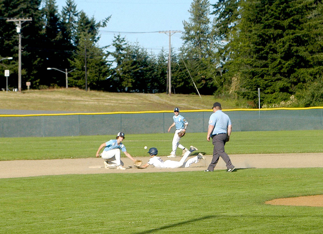 Pierre LaBossiere/Peninsula Daily News Wilder Jr.’s Landon Seibel safely slides into second base against Lynden Christian at Volunteer Field on Monday. Wilder Jr. won 10-3 to finish its league season with a 10-3 record, assuring either second or third place in the NW Area 1 AA American Legion League.
