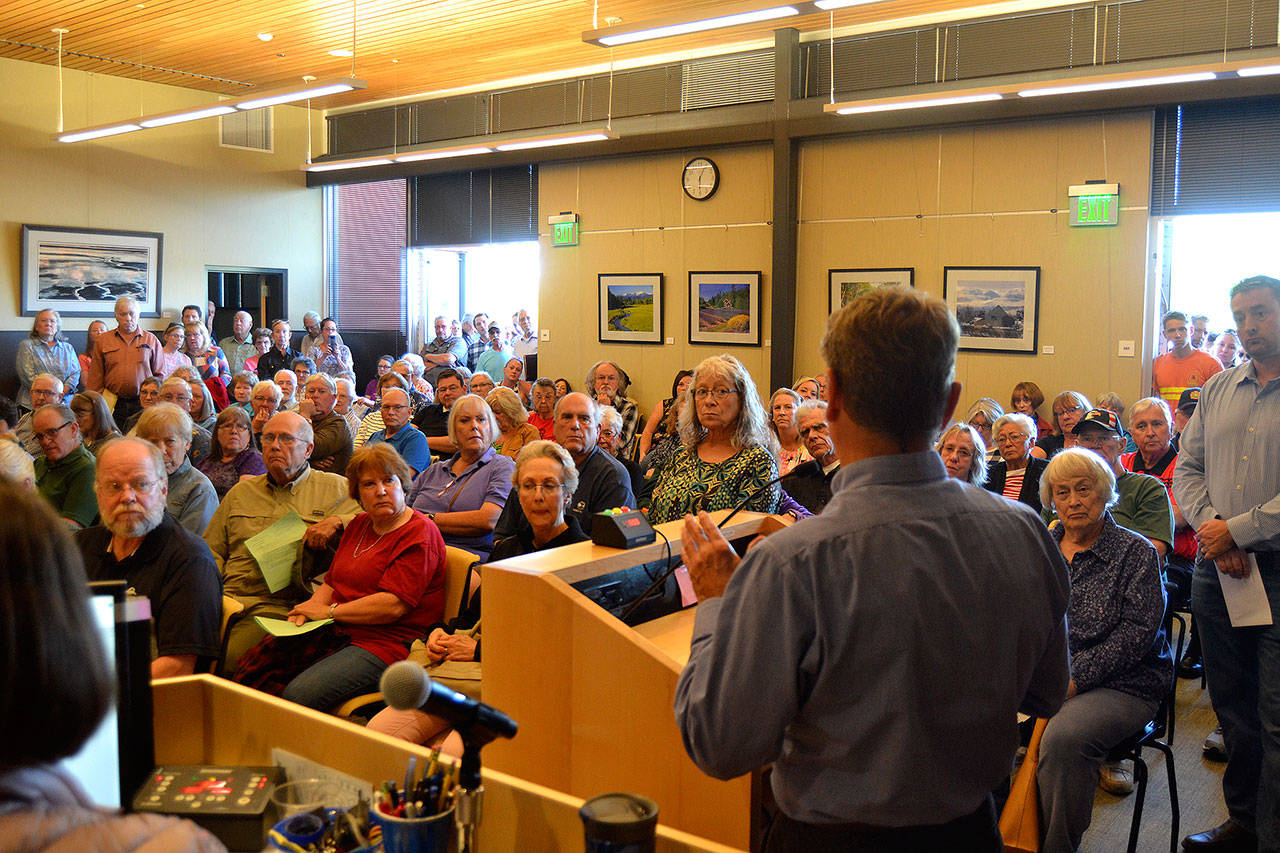 Barry Berezowsky, Sequim director of community development, addresses a crowd of more than 150 people during a Sequim City Council meeting, saying that there’s no proposal before city staff about the much talked about medication-assisted addiction treatment (MAT) facility. He said if a proposal does come in, it’ll will go before the Planning Commission. Sequim Gazette photo by Matthew Nash