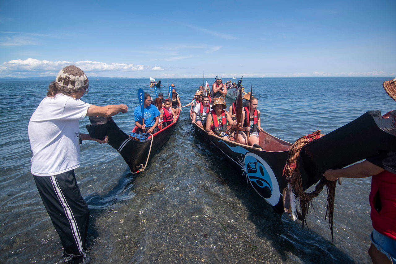 Canoes land at the Lower Elwha Klallam Tribe’s reservation on Sunday during the Paddle to Lummi. (Jesse Major/Peninsula Daily News)