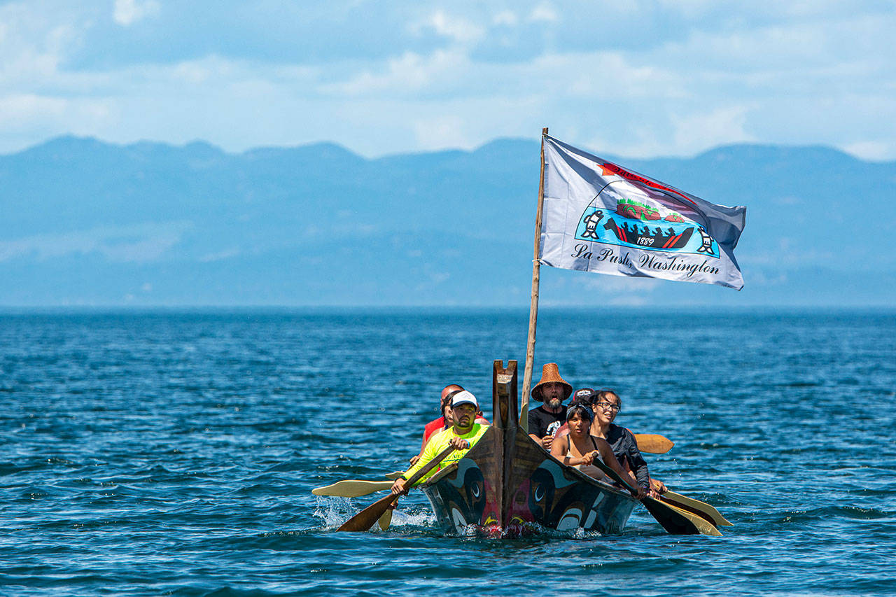 Members of the Quileute Tribe arrive at the Lower Elwha Klallam Tribe’s reservation during the Paddle to Lummi on Sunday. (Jesse Major/Peninsula Daily News)