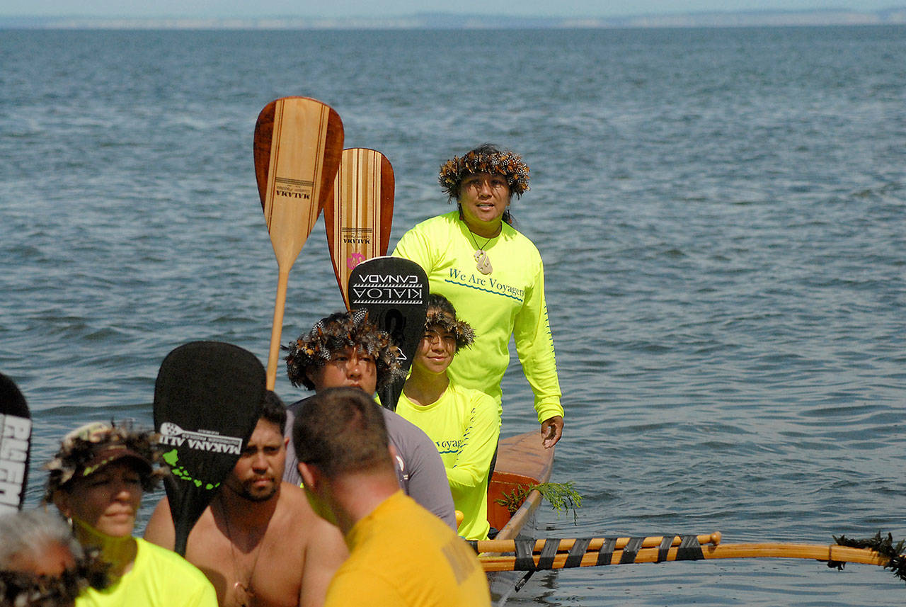 Anela Gutierrez of the Autumn Rose canoe of Maui, Hawaii, asks for permission for her canoe to come ashore at Jamestown Beach north of Sequim on Tuesday. (Keith Thorpe/Peninsula Daily News)