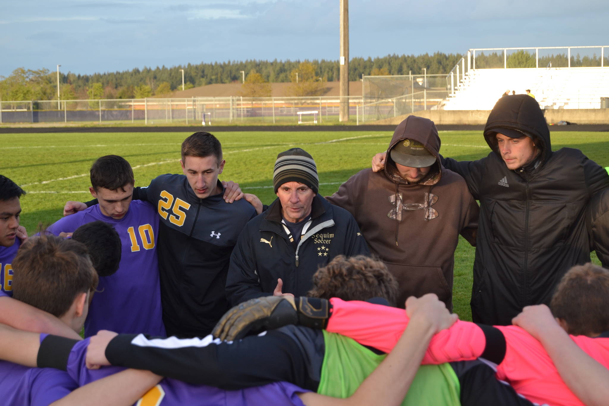 Head coach Dave Brasher talks with his Sequim High players in an April 26 match against North Mason. This year’s Wolves went undefeated in league play for the first time in the program’s history, placing second at districts. Sequim Gazette file photo by Matthew Nash