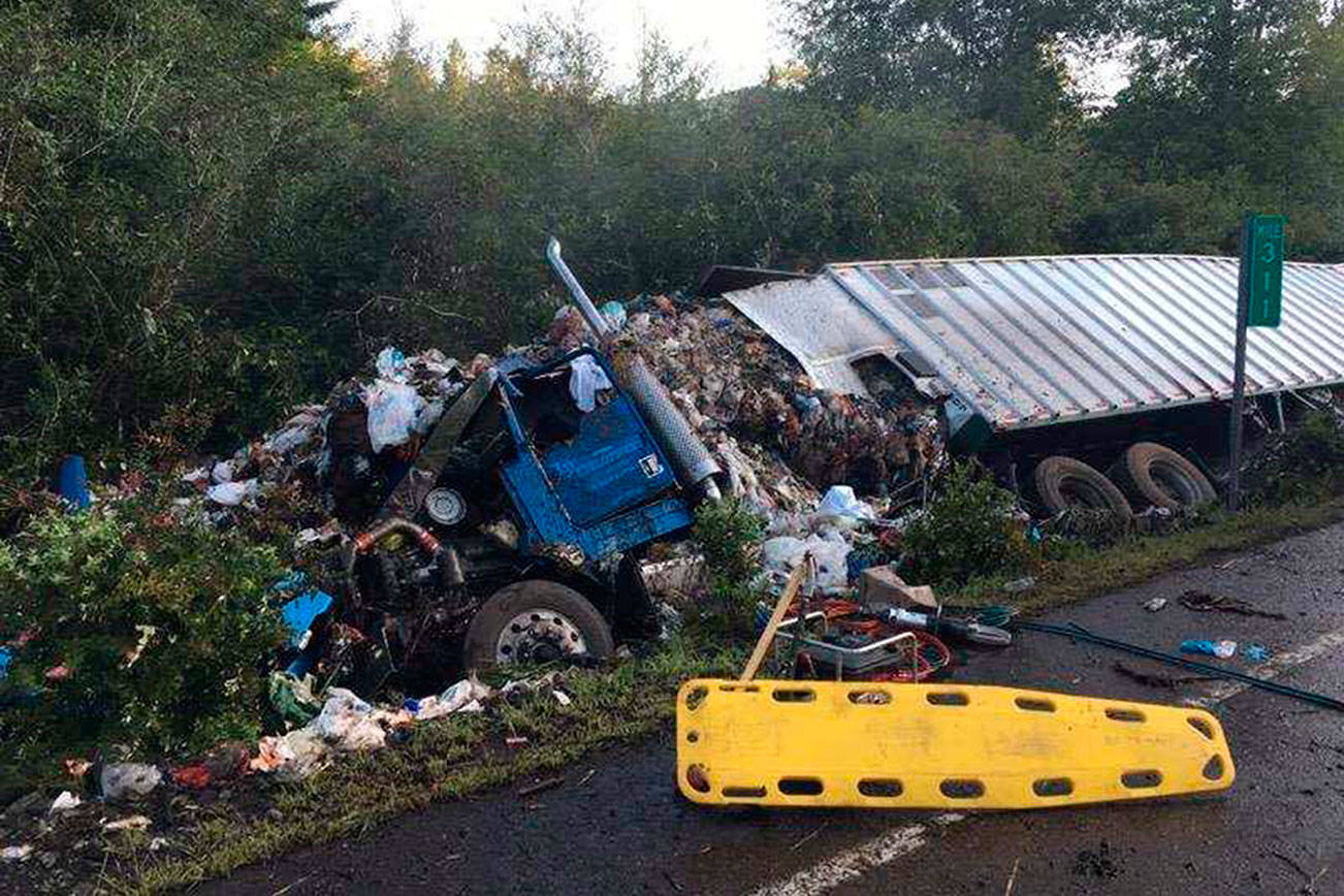 Tractor-trailer crash spills garbage onto Highway 101 near Brinnon