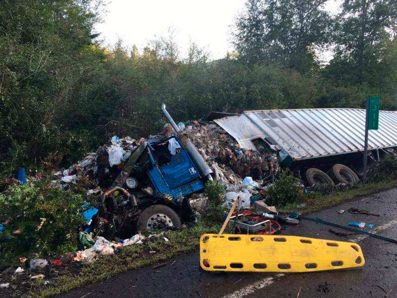 A semi-truck with a 50-foot trailer crashed into a ditch on U.S. Highway 101 on Monday morning. The driver was airlifted to Harborview Medical Center in Seattle. (Washington State Patrol)