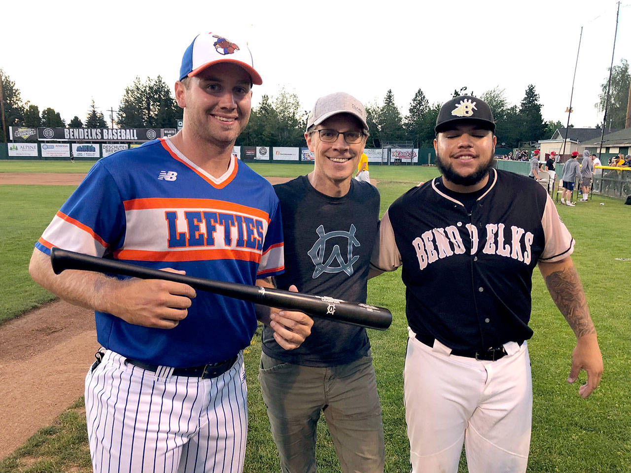 Port Angeles Lefties all-star Matthew Christian, left, is joined by West Coast League Commissioner Rob Neyer and Bend Elks’ slugger Gabe Gonzalez after Christian defeated Gonzalez in the WCL Home Run Derby Monday night at Vince Genna Stadium in Bend, Ore.                                West Coast League
