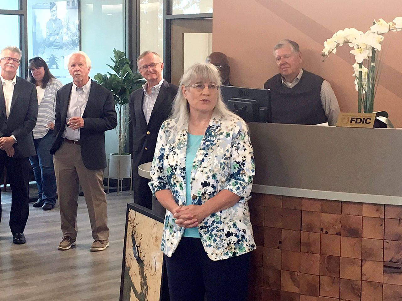 Karen McCormick is honored at a retirement ceremony at the First Federal branch in east Port Angeles. McCormick started as a teller at the branch in 1977 and later became First Federal CEO and First Federal Community Foundation executive director. (Rob Ollikainen/Peninsula Daily News)