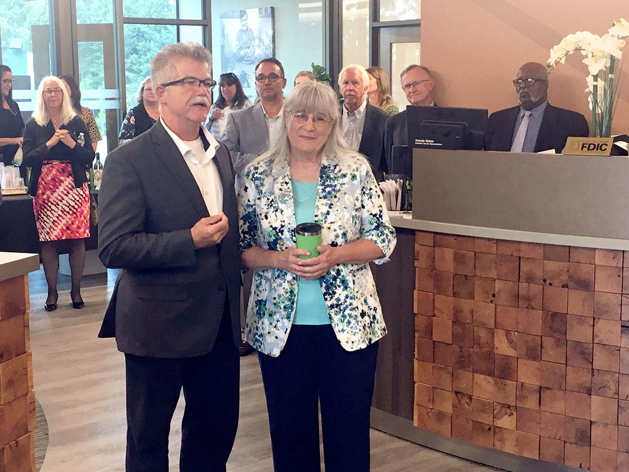Karen McCormick is honored at a retirement ceremony at the First Federal branch in east Port Angeles. Pictured with McCormick is First Federal President and CEO Larry Hueth. (Rob Ollikainen/Peninsula Daily News)