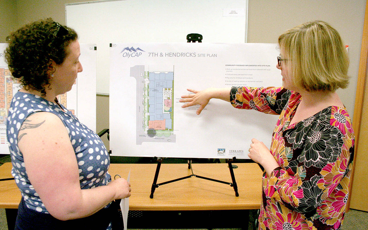 Sarah Jane, left, a nurse who works at Jefferson County Public Health, hears a breakdown of the proposed affordable housing project from Suzanne Davis, the director of community outreach and project manager from Third Place Design Cooperative of Seattle. (Brian McLean/Peninsula Daily News)
