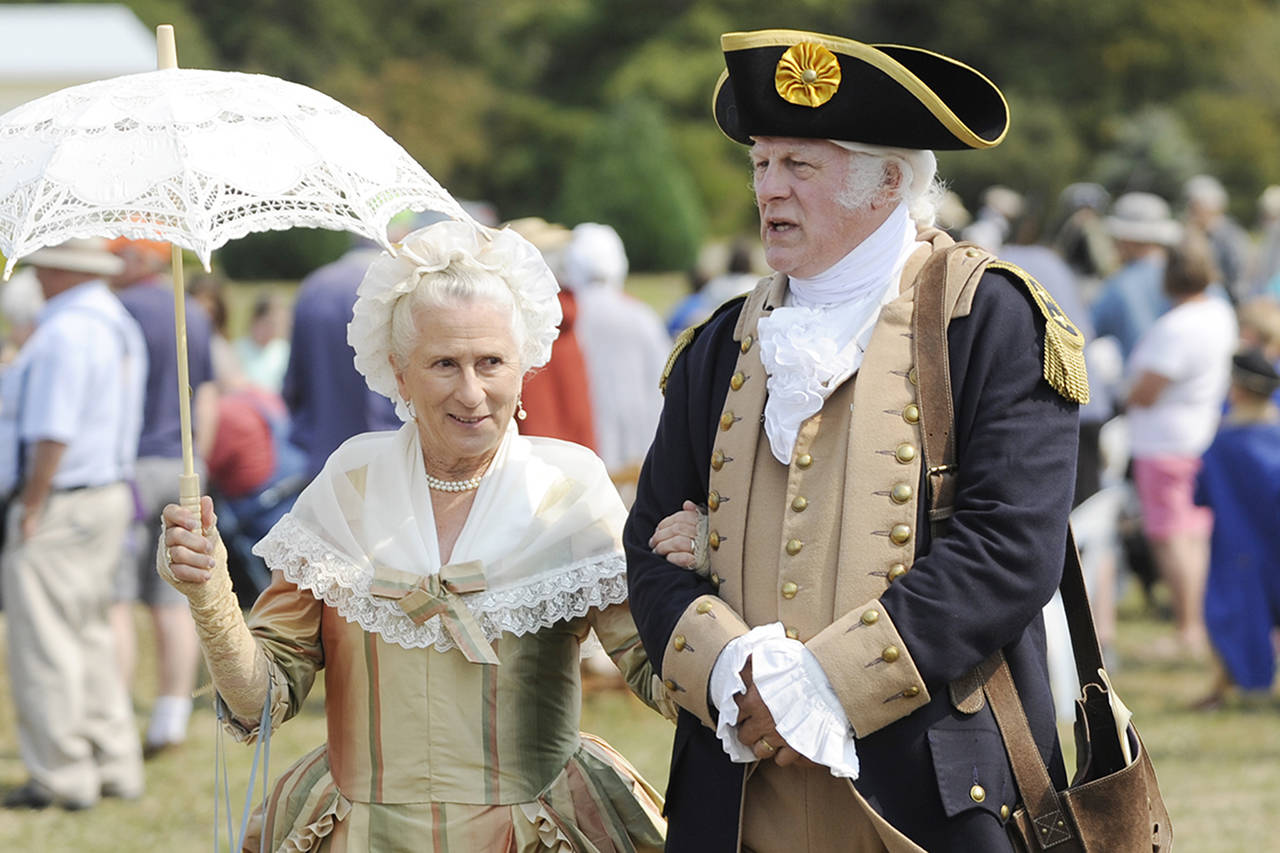 Vern Frykholm, right, walks across the 2018 Colonial Festival portraying George Washington alongside Jane Ritchey, left, portraying Martha Washington. (Michael Dashiell/Olympic Peninsula News Group)