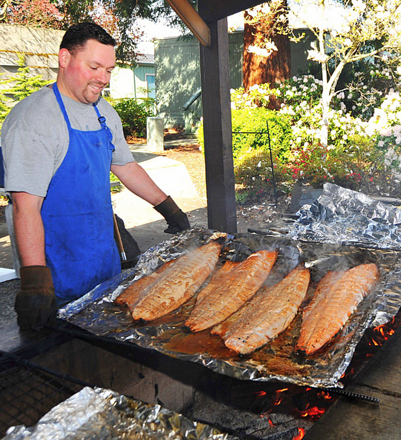 A Rotary Club member prepares wild salmon for guests. (Rotary Club of Sequim)