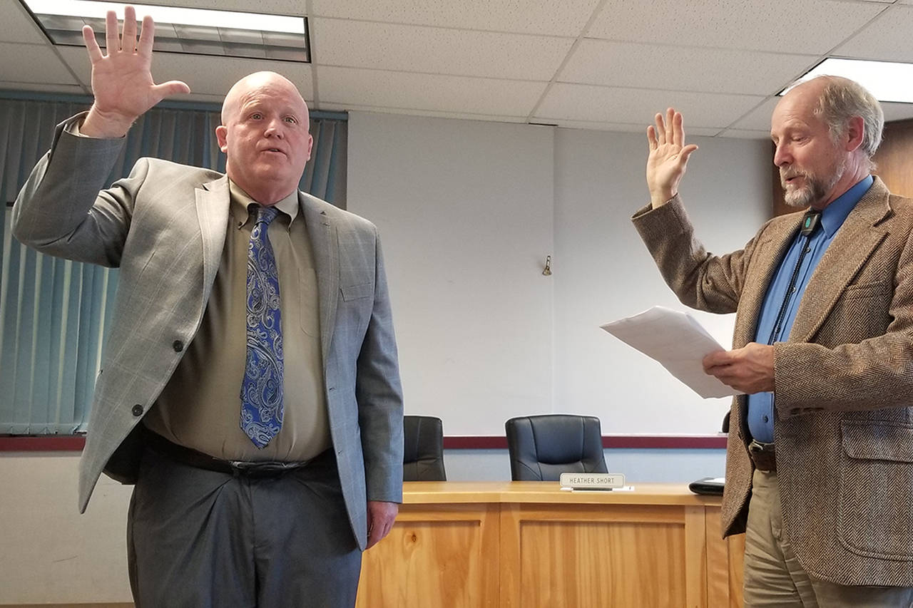 Rob Clark is officially sworn in as the interim superintendent of the Sequim School District by Judge Brian Coughenour at the Monday school board meeting. (Conor Dowley/Olympic Peninsula News Group)