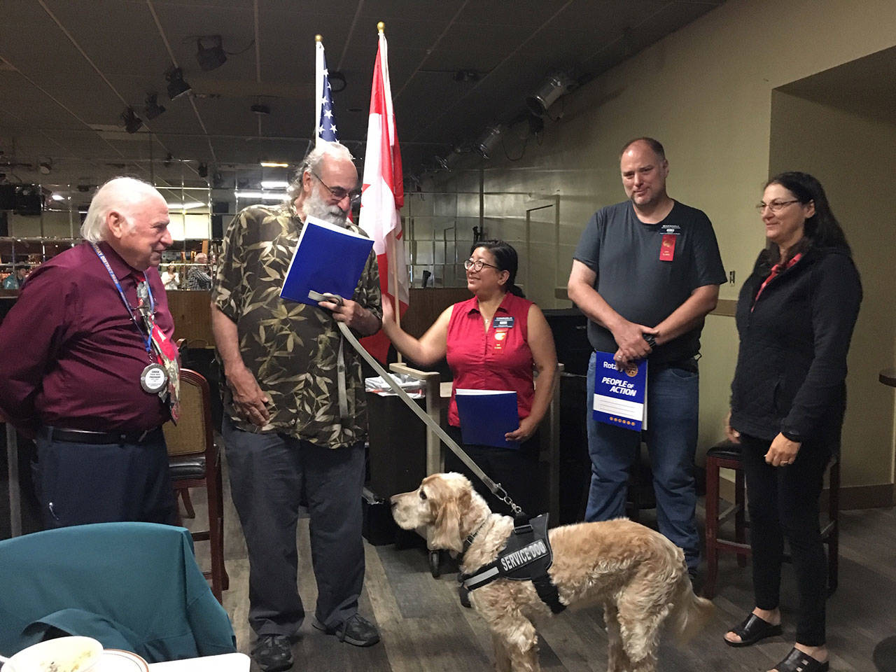 From left, Chuck Henry, Port Townsend Sunrise Rotary president; new Rotarians John Pope, Consuelo Brennen and Marshall Brennen; and Rotarian Jayne Neu. Moby Dick, the club’s first canine member, is in front.