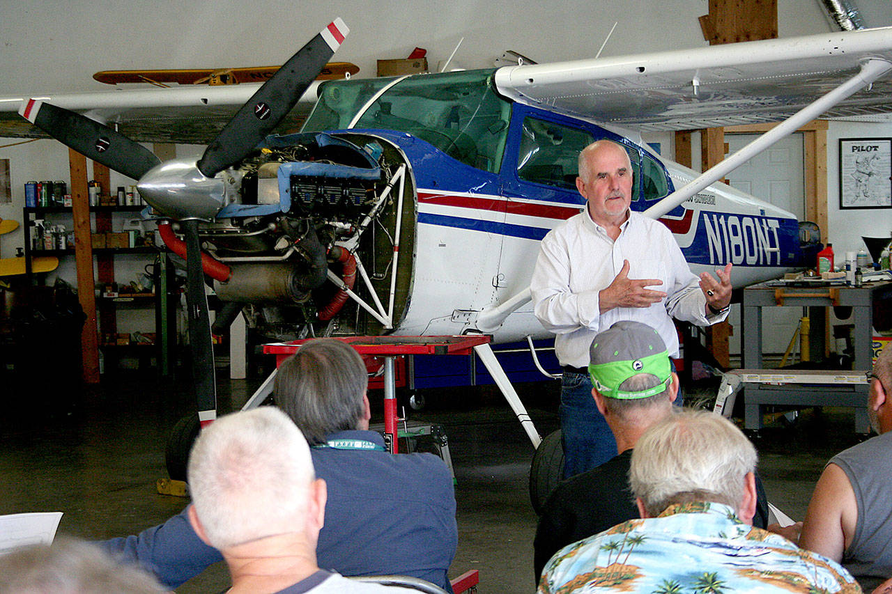 Jim Pivarnik, the executive director of the Port of Port Townsend, discusses the runway reconstruction project scheduled for next spring with pilots Wednesday inside Tailspin Tommy’s hangar at Jefferson County International Airport. (Brian McLean/Peninsula Daily News)