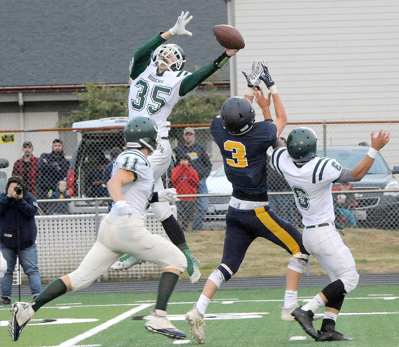 Lonnie Archibald/for Peninsula Daily News Port Angeles’s Derek Bowechop (35) leaps high to deflect a Forks pass in last season’s season opener. The two area teams will meet at Civic Field on Friday, Sept. 6.