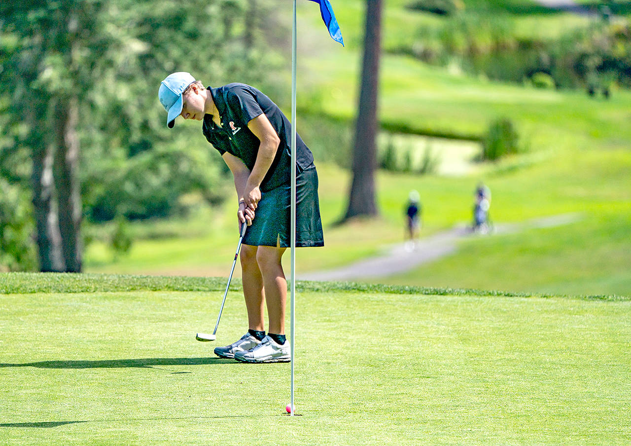 Port Townsends Mackenzie Lake sinks a 6-foot put on the 18th green during the Pacific Northwest Golf Associations Girls Junior Amateur Championship at Port Ludlow Golf Course on Monday.                                Steve Mullensky/for Peninsula Daily News