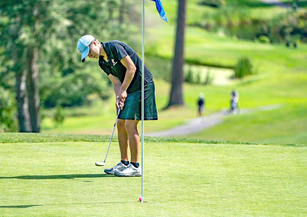 Port Townsend’s Mackenzie Lake sinks a 6-foot put on the 18th green during the Pacific Northwest Golf Association’s Girls Junior Amateur Championship at Port Ludlow Golf Course on Monday.                                Steve Mullensky/for Peninsula Daily News