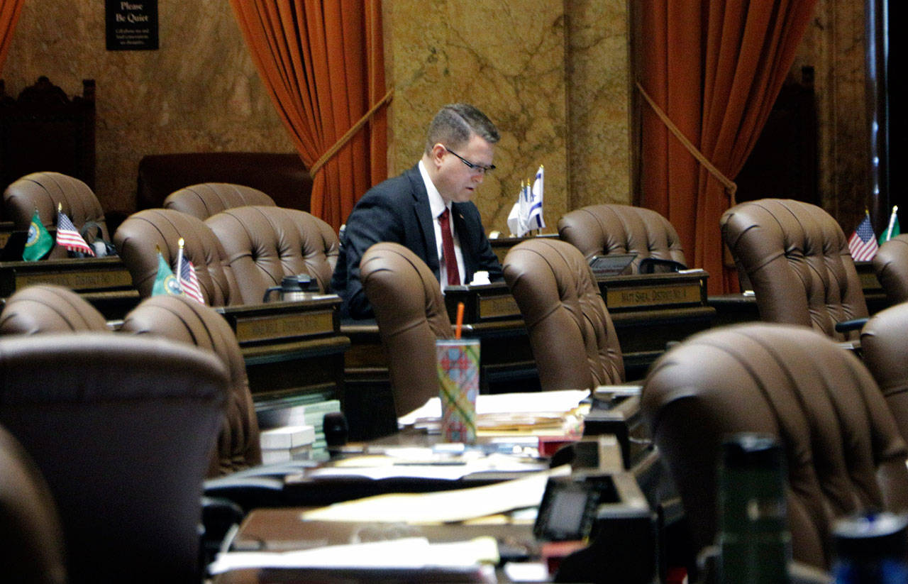 Republican state Rep. Matt Shea sits at his desk on the House floor in April in Olympia. (The Associated Press)
