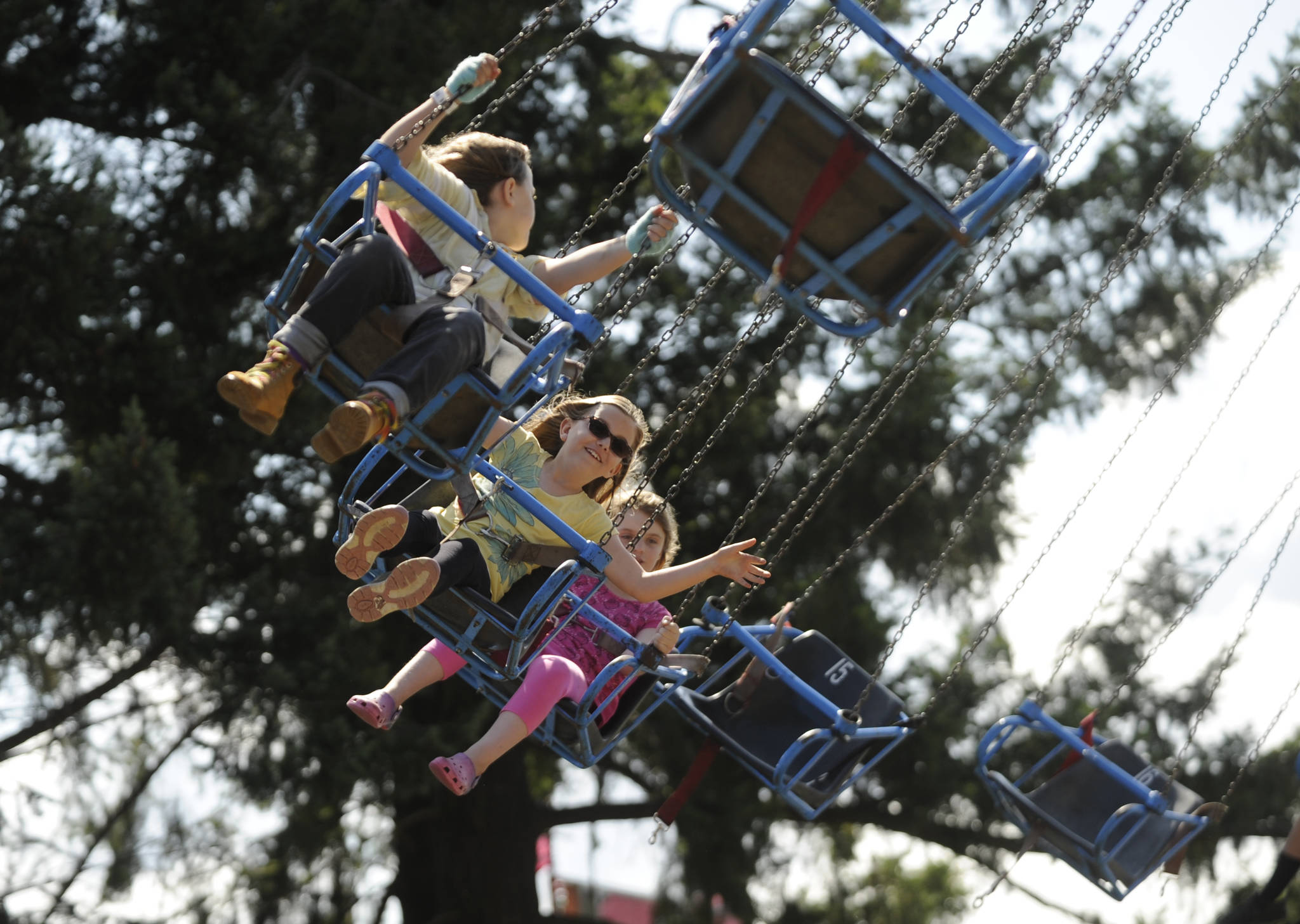 From left, Kiari Latson, 10, Mallory Hartman, 9, and Annelisa Rosenkranz, 8, enjoy a ride at the Clallam County Fair. Michael Dashiell/Olympic Peninsula News Group