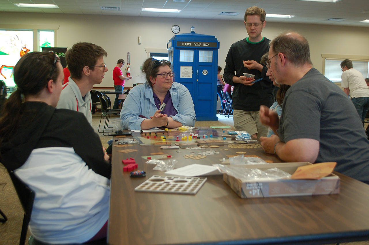 <strong>Conor Dowley</strong>/Olympic Peninsula News Group                                Several people from Sequim and Port Angeles work together to learn a new game at Opttacon 2019 at the Guy Cole Event Center.