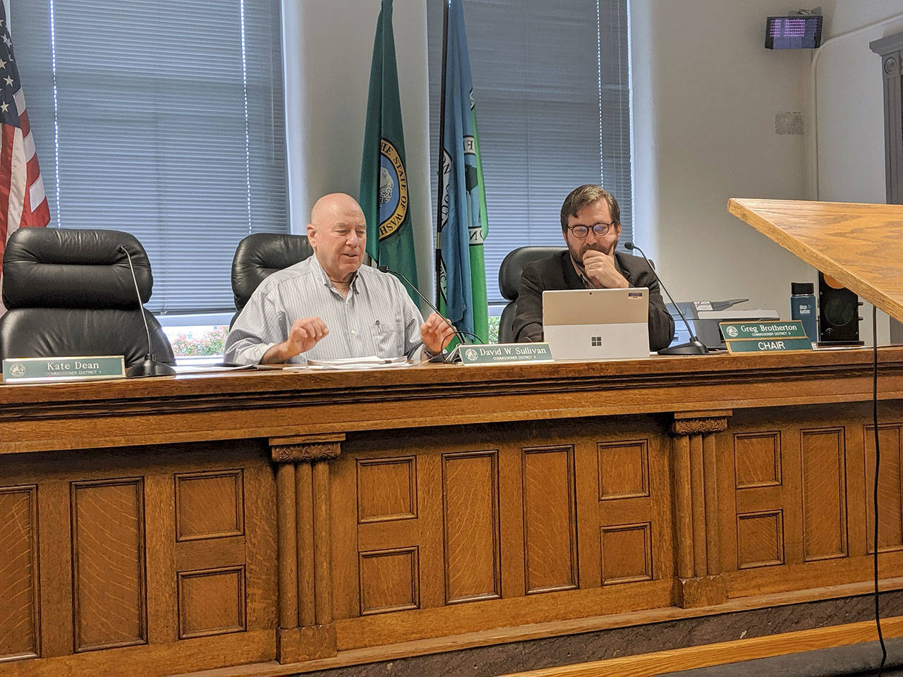 Jefferson County Commissioners David Sullivan, left, and Greg Brotherton discuss the proposed ordinance to allow them to surplus property to OlyCAP at their Aug. 19. (Zach Jablonski/Peninsula Daily News)