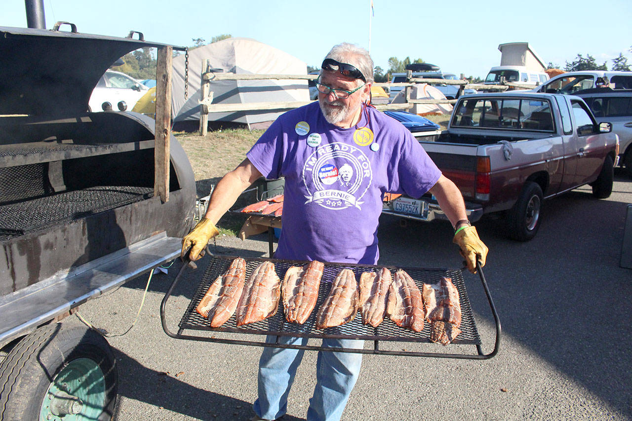 Larry Dennison holds a rack of freshly cooked salmon at the Jefferson Democrats’ Fish Feast on Sunday evening, hosted at the Jefferson County Fairgrounds. Dennison has cooked the salmon for the Fish Feast for 24 years. (Zach Jablonski/Peninsula Daily News)
