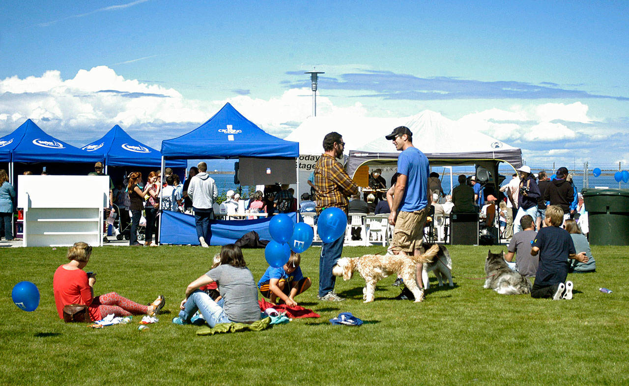 Families and their four-legged friends congregrate in the grass at Waterfront Park in downtown Port Angeles during the Jammin’ in the Park 2016 celebration and fundraiser organized by Nor’Wester Rotary. (Peninsula Daily News file photo)