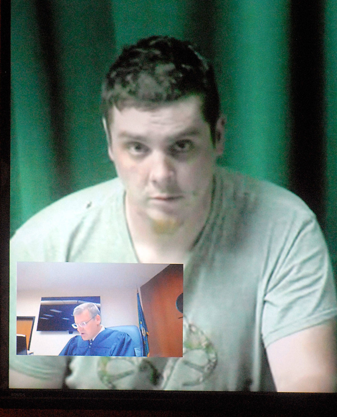 Jason Hutt appears by video link during his first appearance in Clallam County Superior Court on Tuesday. Judge Brent Basden is shown in the video inset. (Keith Thorpe/Peninsula Daily News)