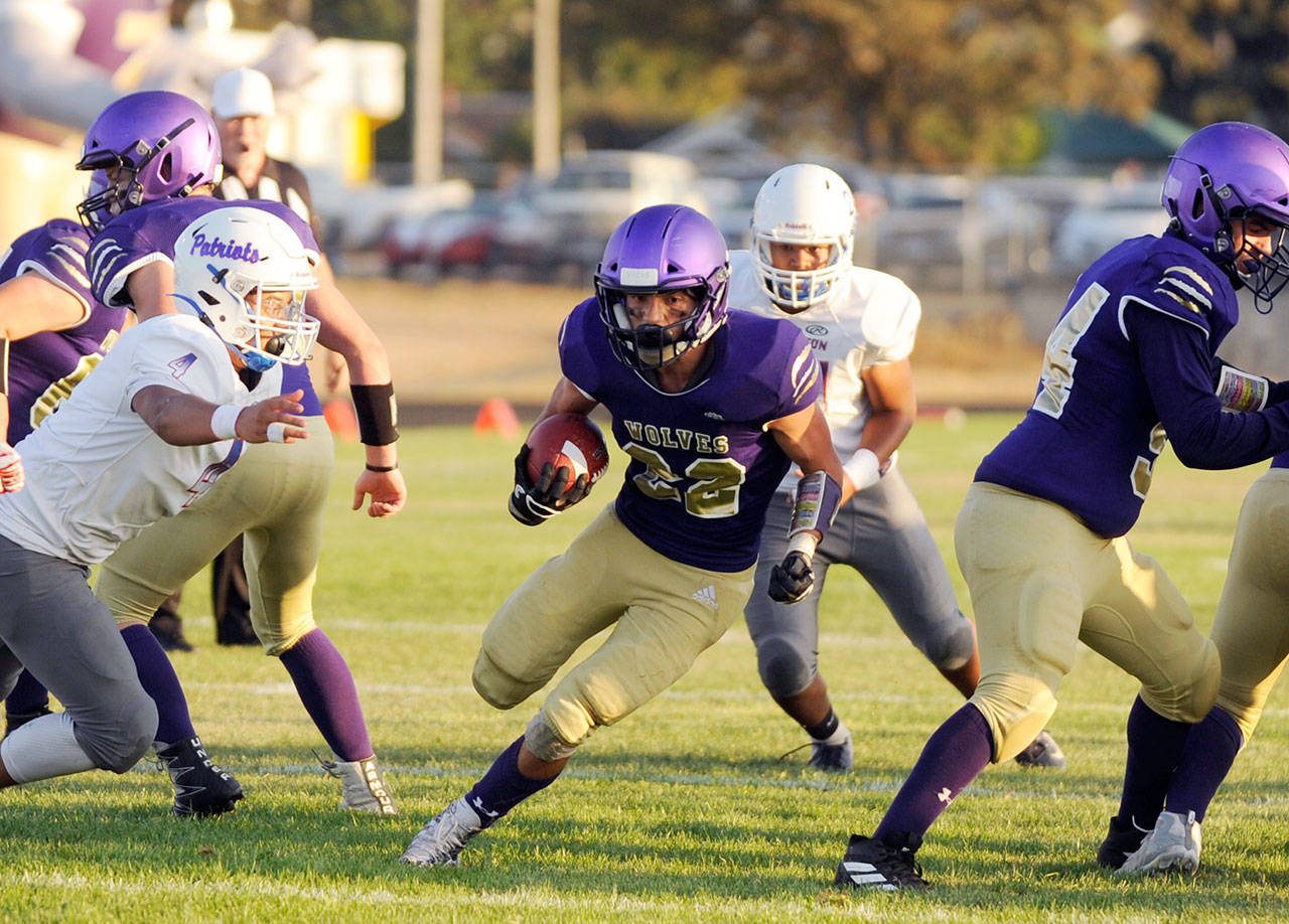 Michael Dashiell/Olympic Peninsula News Group Sequim running back Walker Ward crossed the goalline for a touchdown in the first quarter of the Wolves’ non-league game against Washington on Sept. 6.