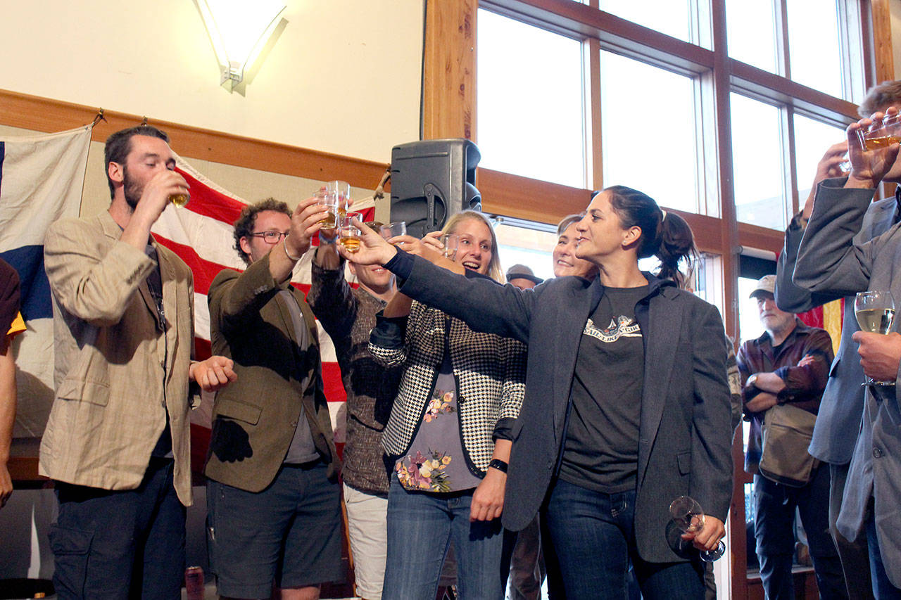 Members of the top five teams to finish the Race to Alaska share a drink at the Blazer Party, after they were declared the winners of the “teams most in need of a stiff drink” awards because of the rough seas and weather they faced. (Zach Jablonski/Peninsula Daily News)
