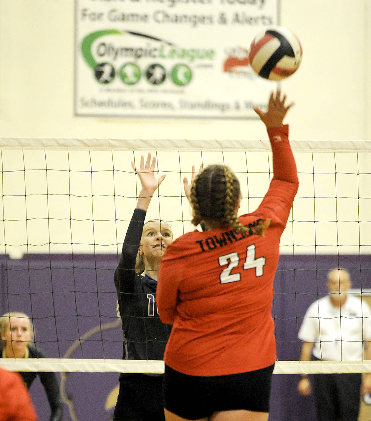 Port Townsend senior Tori Minnihan (24) looks for a big hit as Sequim freshman Kendall Hastings vies for a block in the opening match of Sequim’s volleyball jamboree Monday. Sequim swept the Redhawks in three games. The jamboree saw round-robin play between Sequim, Port Angeles and Port Townsend.