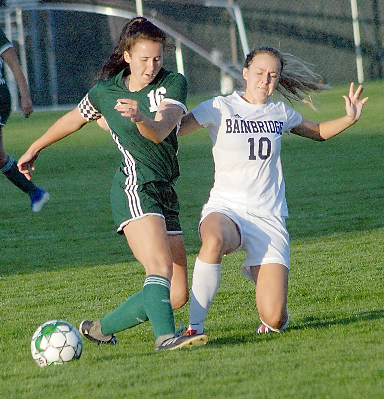 <strong>Keith Thorpe</strong>/Peninsula Daily News                                Port Angeles’ Delaney Wenzl, left, fends off the defensive efforts of Bainbridge’s Eden Hagen at Civic Field on Tuesday.